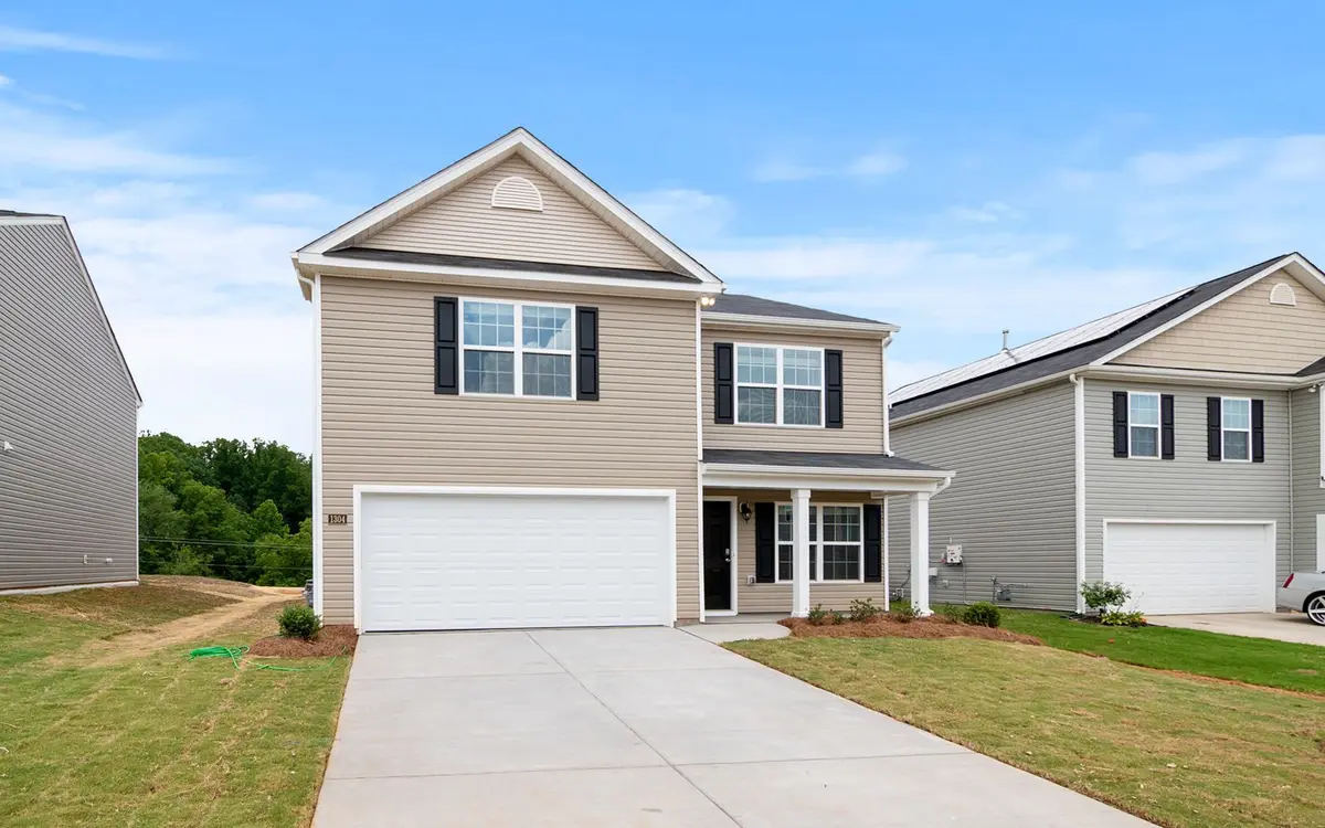 A new suburban home with a driveway and lawn